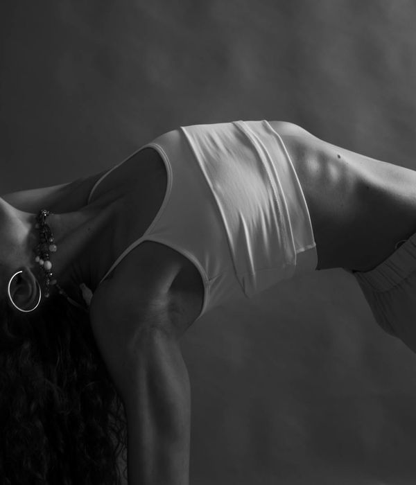 Woman in a peaceful yoga pose focusing on core stability and posture